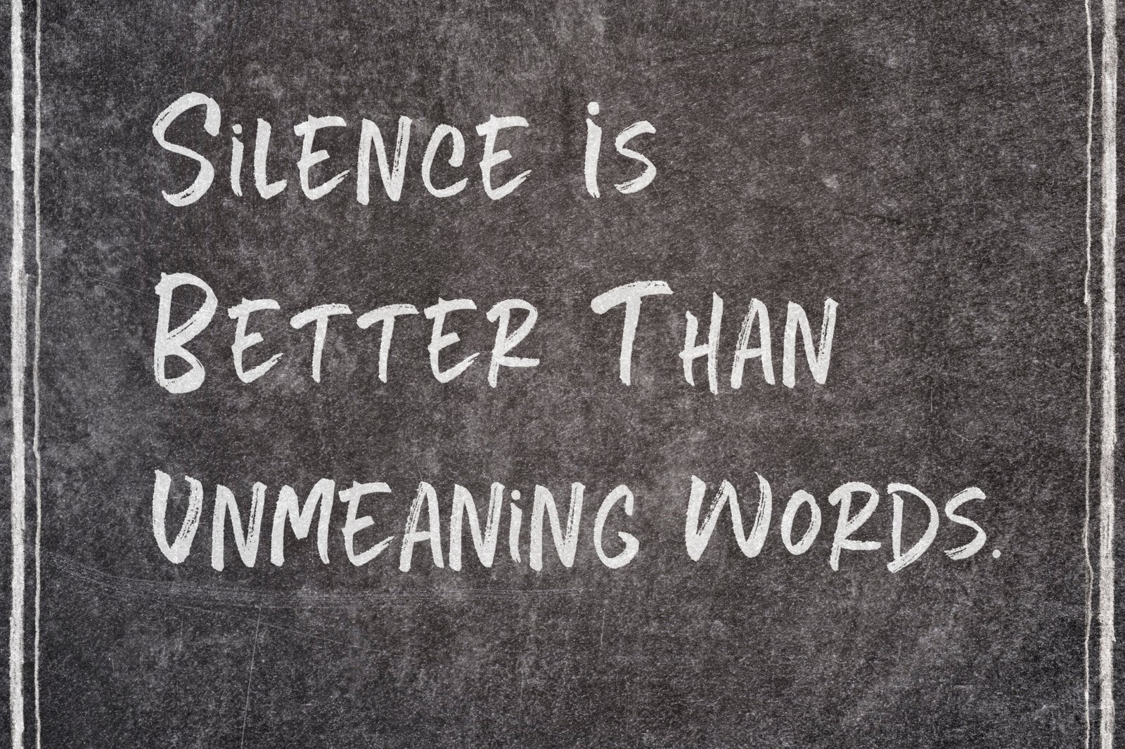 A chalkboard with the handwritten words: silence is better than unmeaning words